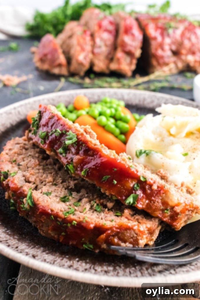 2 slices of meatloaf on a plate with mashed potatoes