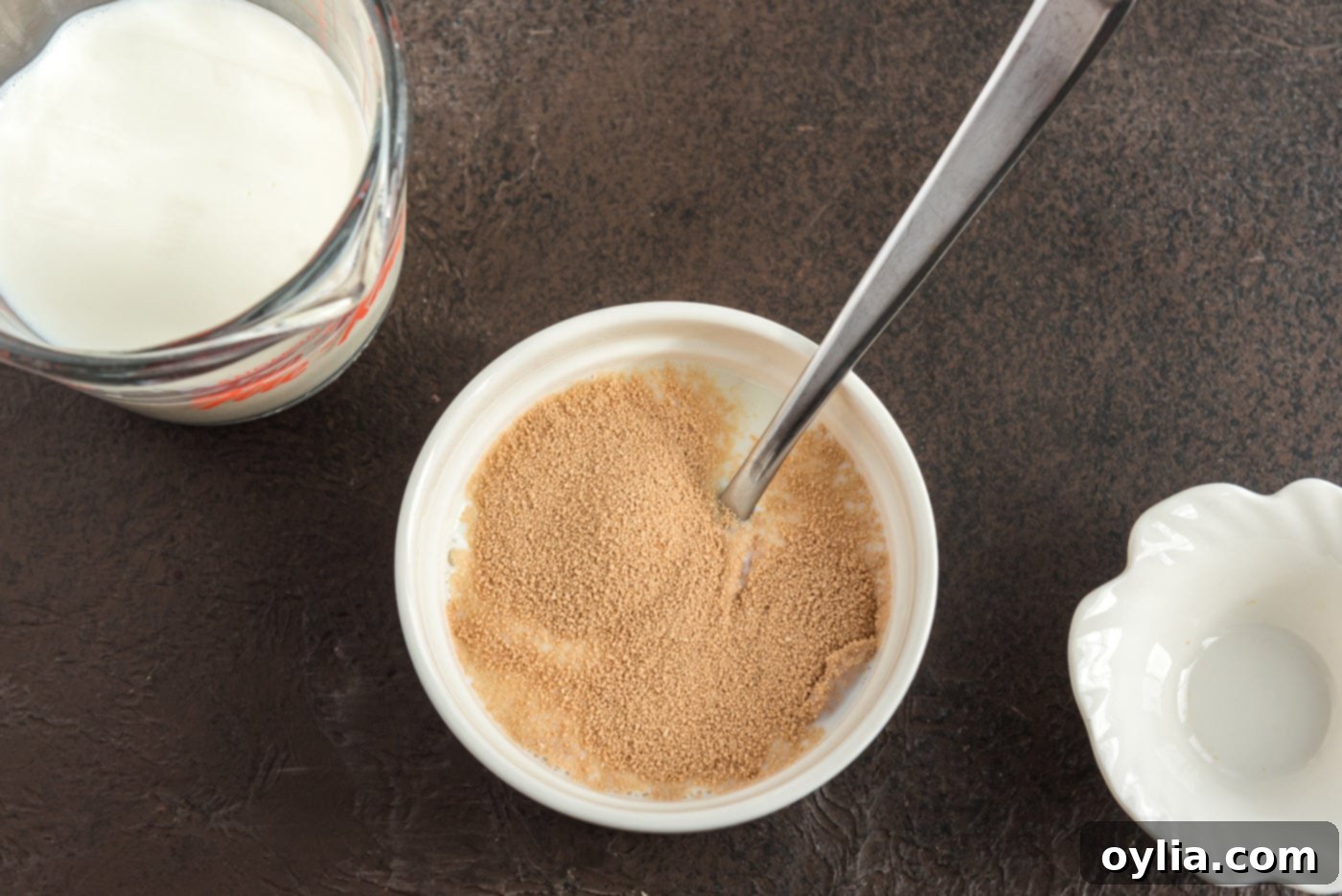 mixing active dry yeast with milk in a bowl