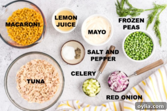Creamy Tuna Pasta Salad 2 A colorful array of ingredients for tuna macaroni salad laid out on a cutting board