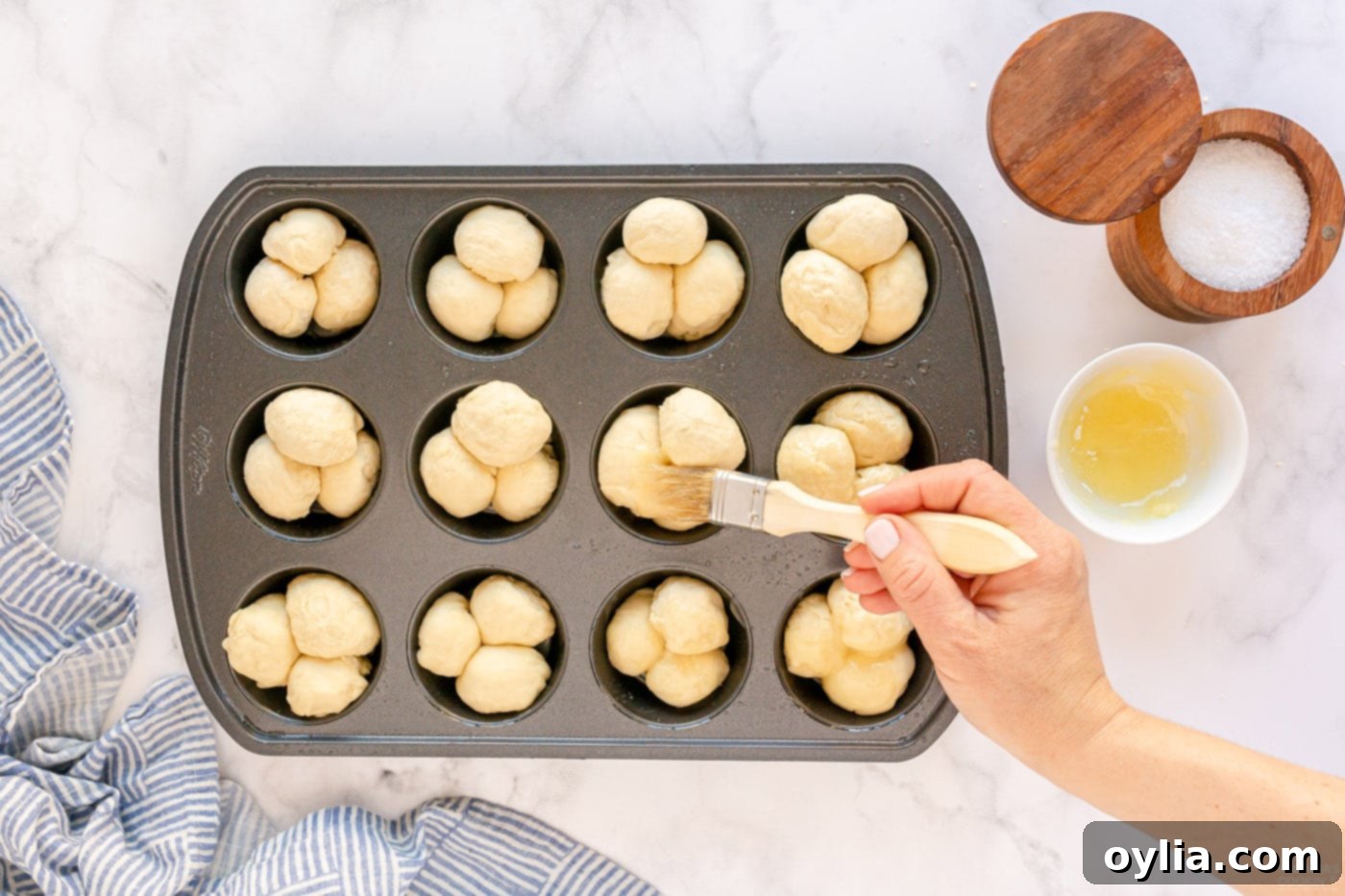 brushing dough with butter