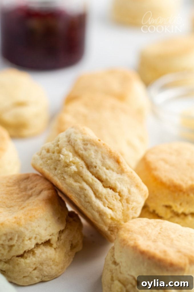 A beautiful stack of golden, fluffy biscuits, highlighting their soft interior and crispy edges