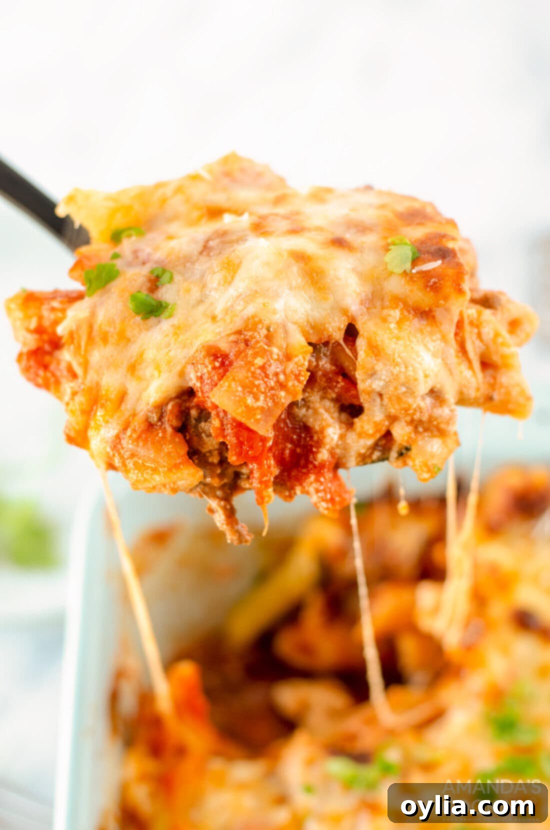 Savory Layered Pasta Dream 3 serving spoon of baked ziti