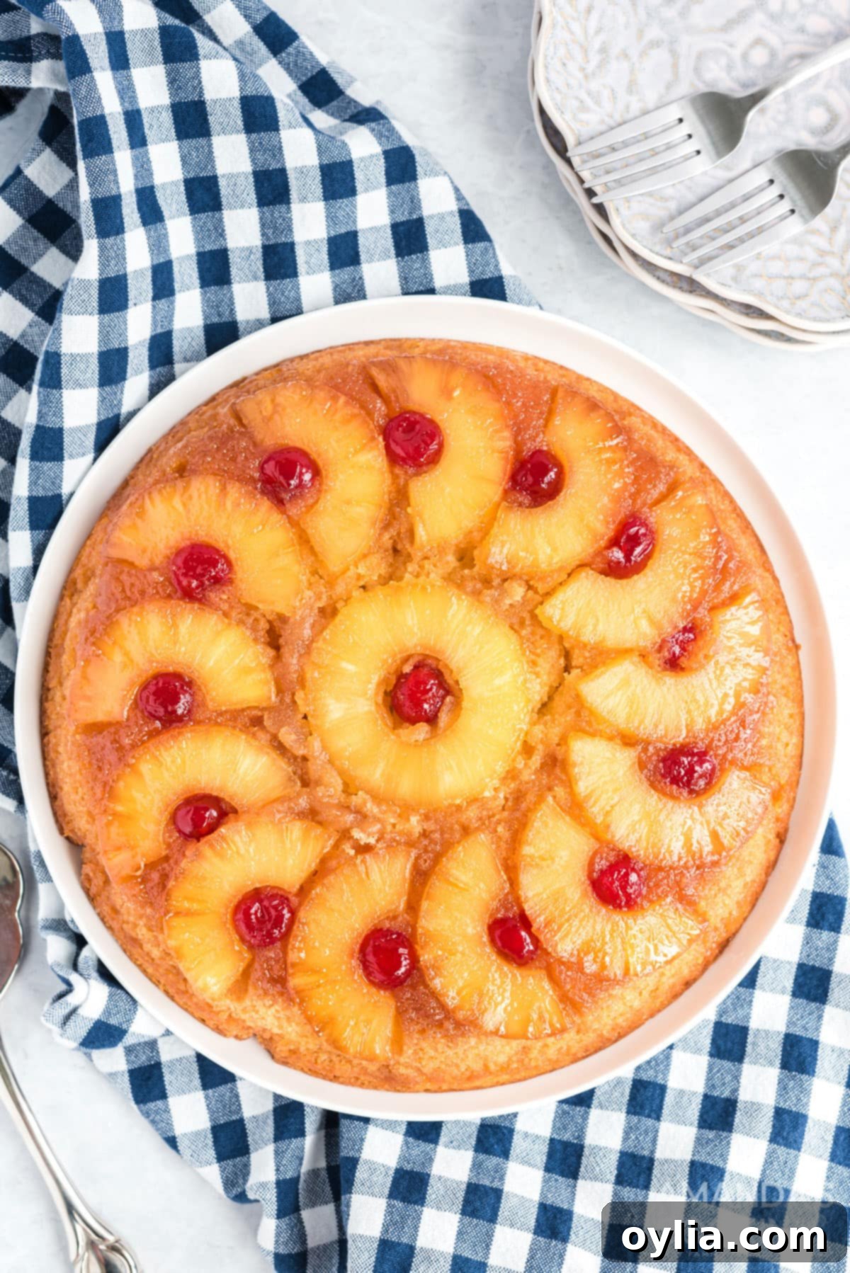 Overhead photo of a beautifully baked pineapple upside down cake in a cast iron skillet, golden and caramelized