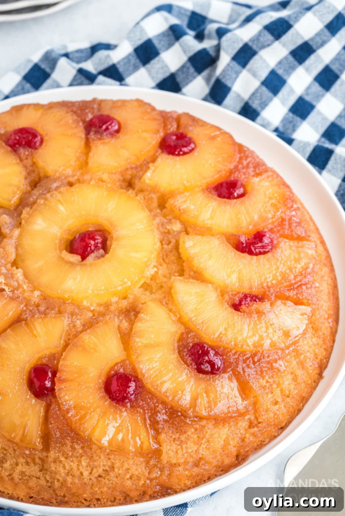 Close-up of a perfectly baked slice of pineapple upside down cake, showing the moist cake and rich caramel topping.