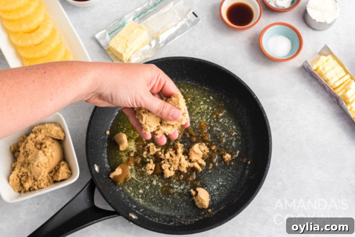 Adding rich brown sugar evenly over melted butter in a hot cast iron skillet.