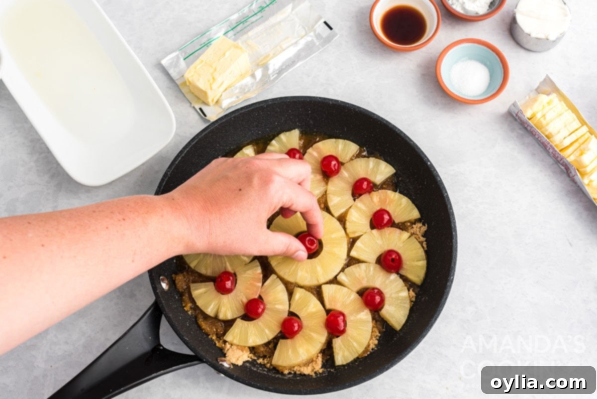 Adding bright maraschino cherries into the center of each pineapple ring for a festive touch.