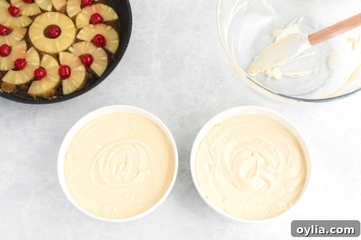 Divided cake batter in two separate bowls, ready for pouring into skillets.