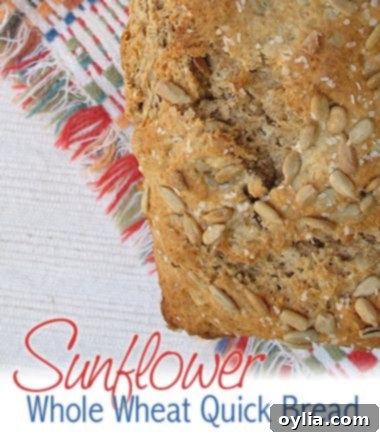 Close-up of a rustic loaf of sunflower quick bread, highlighting its golden crust and visible sunflower seeds.