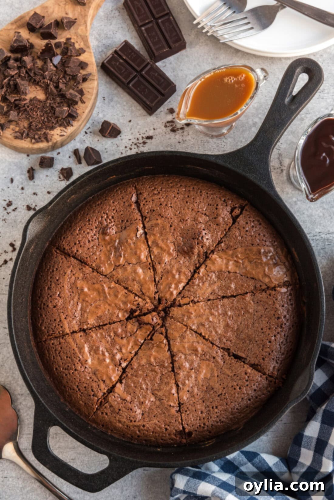 A cast iron skillet filled with freshly baked, fudgy brownies, expertly cut into perfect triangular slices, ready for serving.