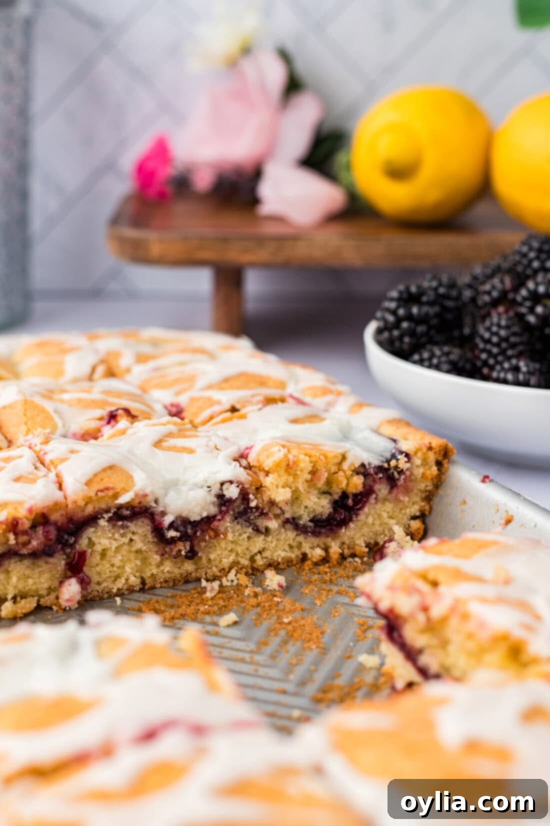 Side view of Blackberry Pie Squares in a baking pan with some squares removed, showing the layers