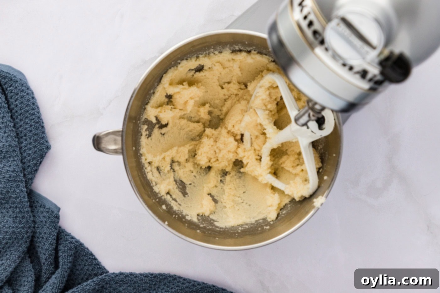 Butter and sugar mixture being beaten with a stand mixer until fluffy