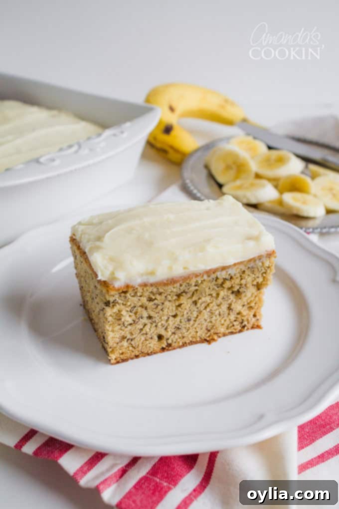 Deliciously moist Banana Cake with Vanilla Cream Cheese Frosting on a cooling rack