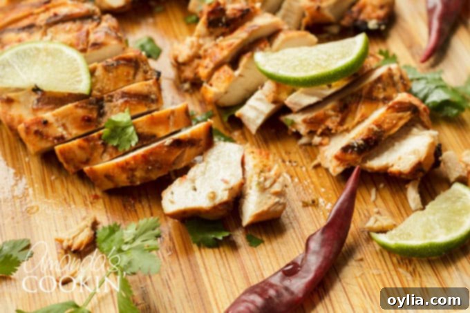 Close-up of juicy, tender Chile Lime Chicken on a cutting board, emphasizing its texture and appeal.