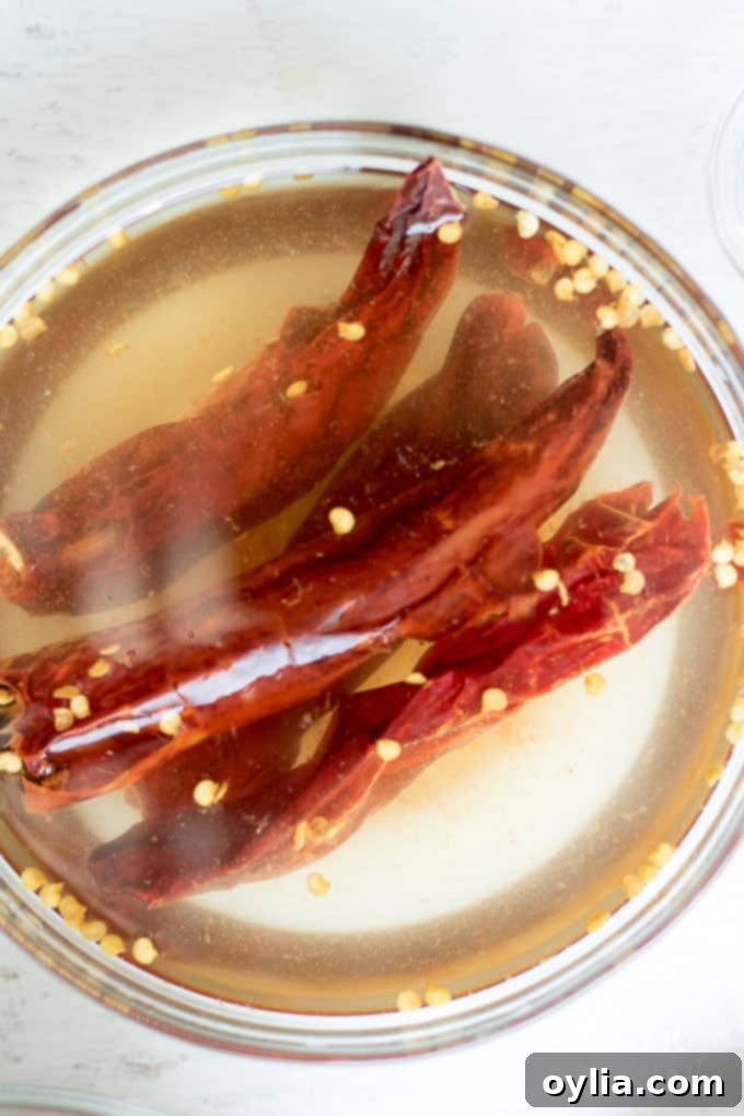 Step-by-step: Carefully remove seeds from rehydrated chiles to control spice.