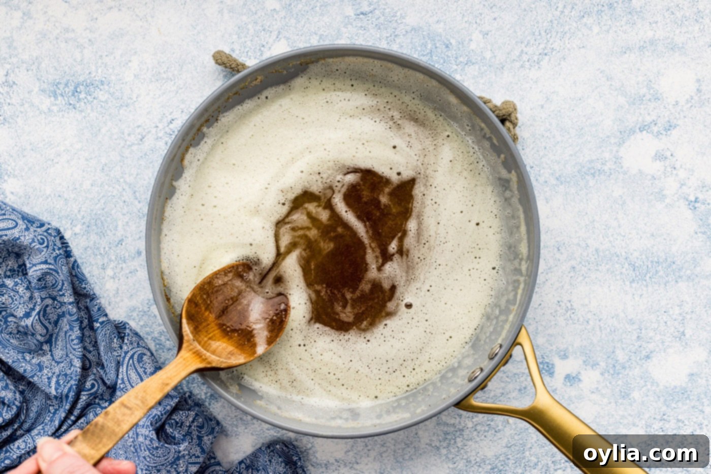 browned butter in a skillet with a wooden spoon