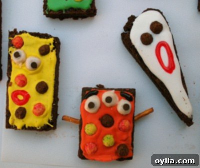 A tray full of colorful and diverse monster brownies, ready for a Halloween party