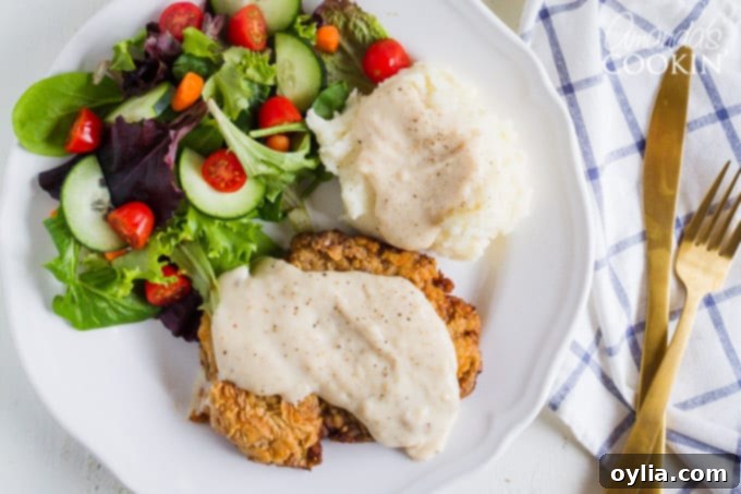 chicken fried steak with gravy and side salad