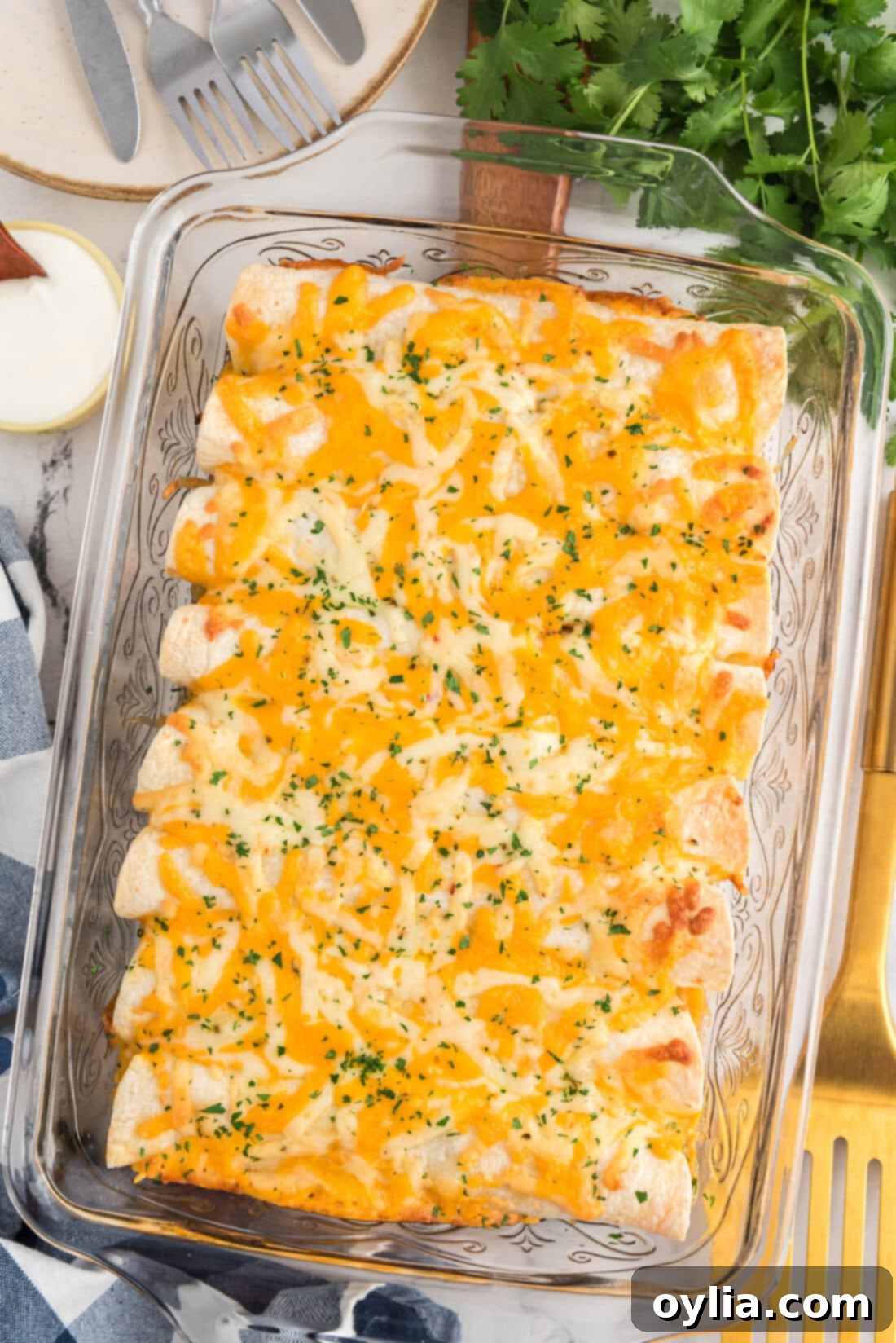 Delicious Shredded Chicken and Green Chile Enchiladas baking in a glass dish