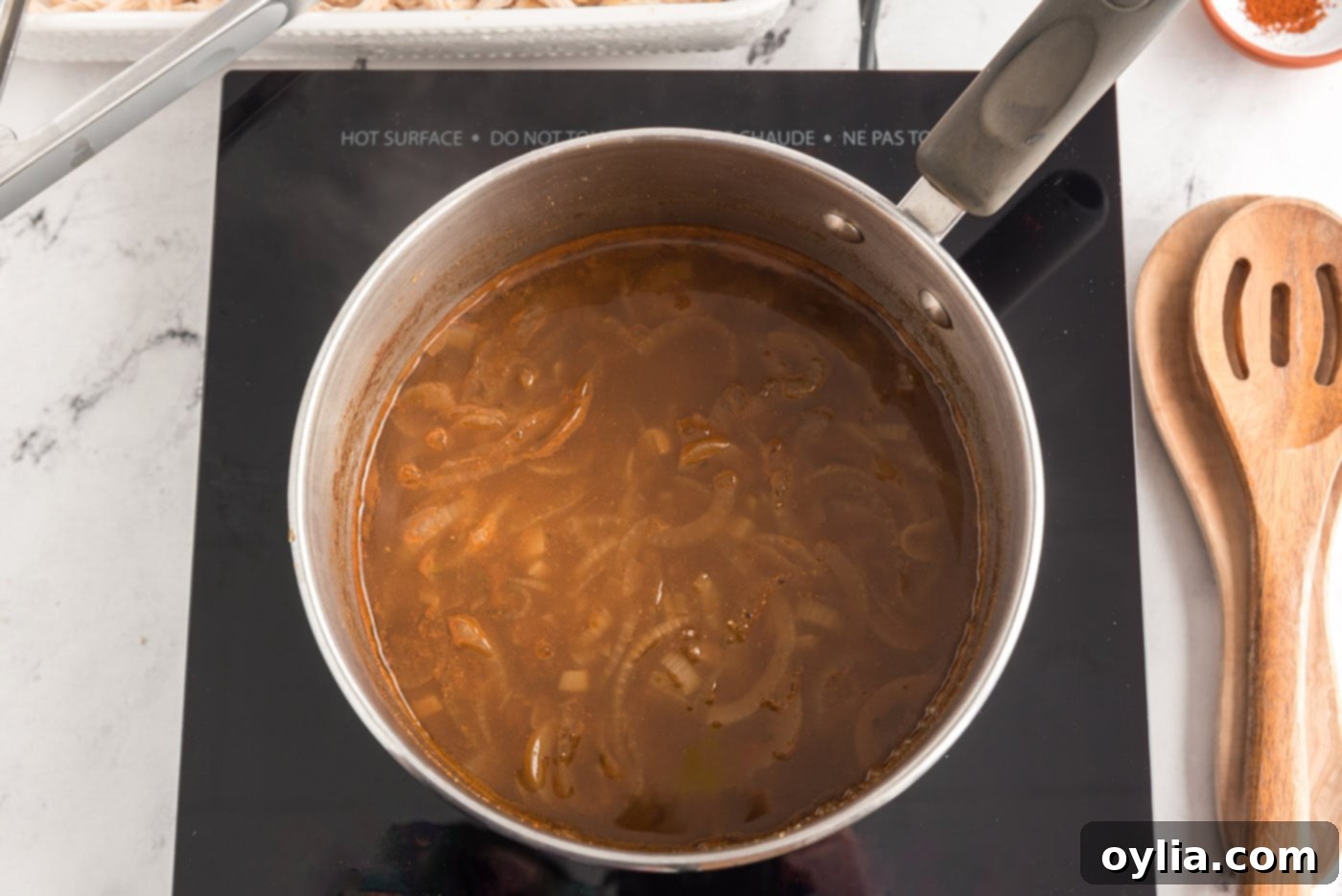 Chicken enchilada filling simmering in a saucepan