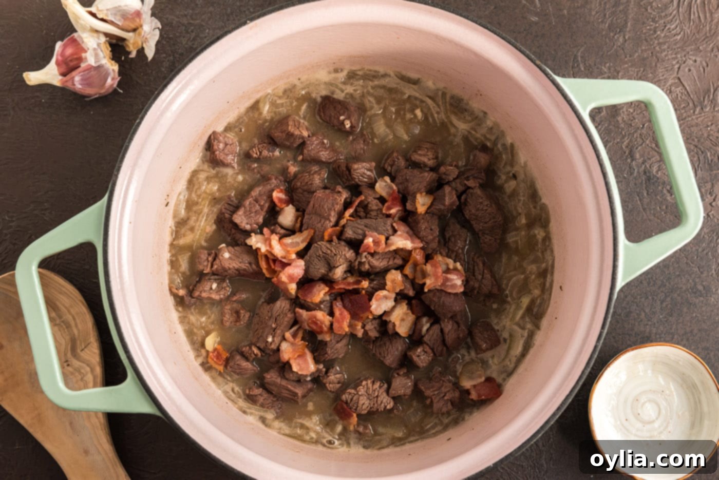 beef and bacon added to pot with onions