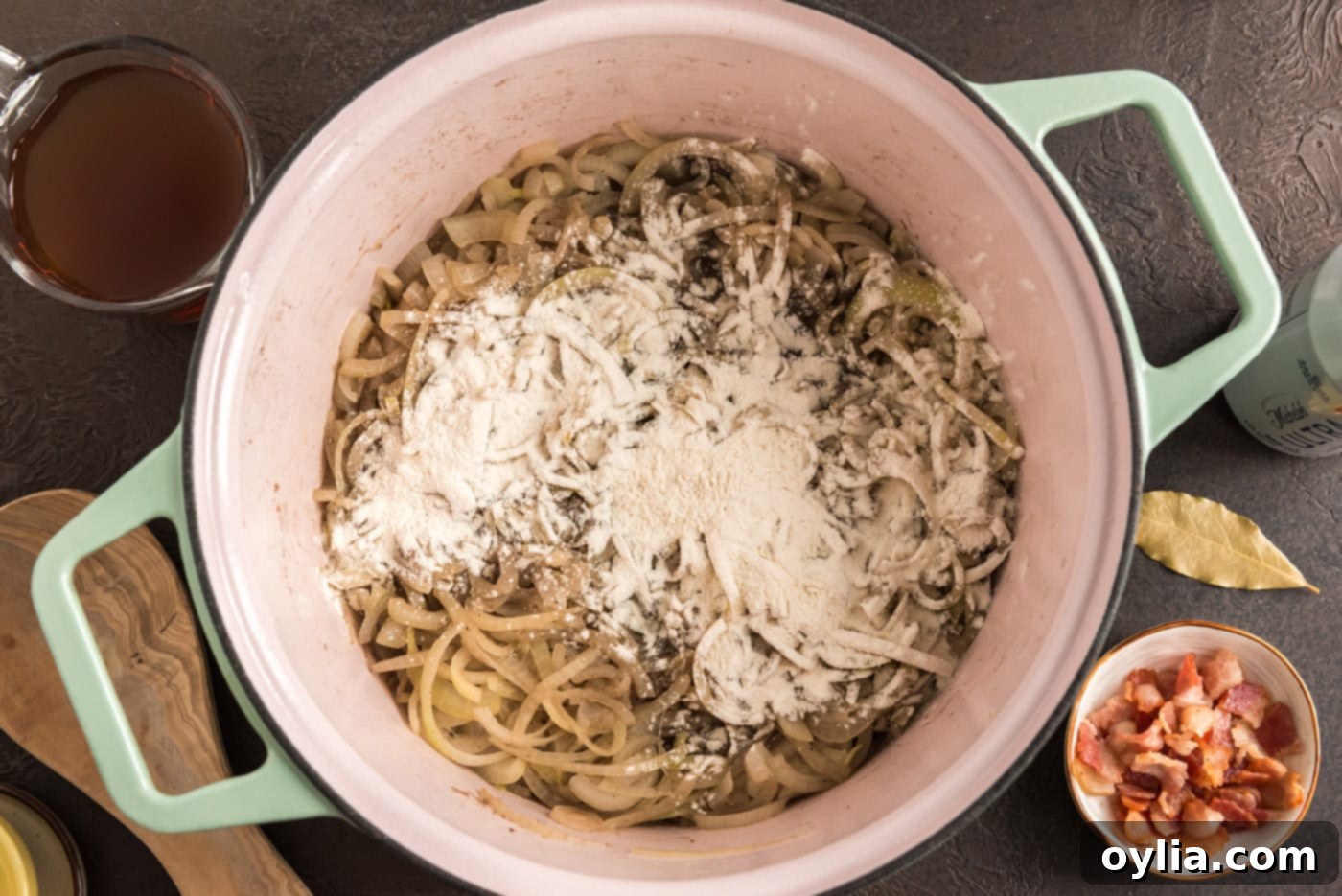 adding flour to dutch oven with onions