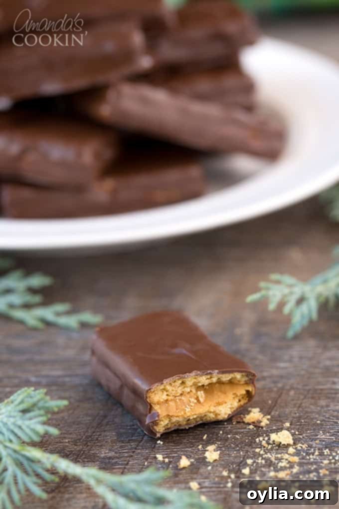 Peanut butter and chocolate lovers and going to go crazy for these super easy to make homemade candy bars. Great for snack or gift giving! #chocolate #candy #desserts #homemade #homemadecandy #candybars #nobake #peanutbutter #valentinesday #peanutbutterdesserts Homemade candy bars in half