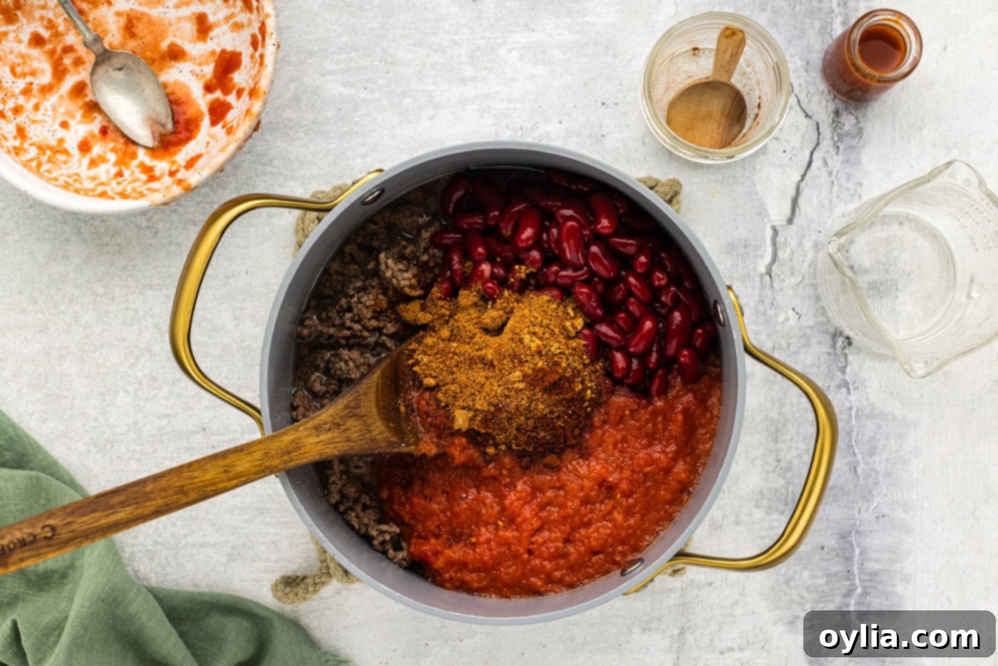 chili seasoning, tomatoes, and beans added to pot with ground beef