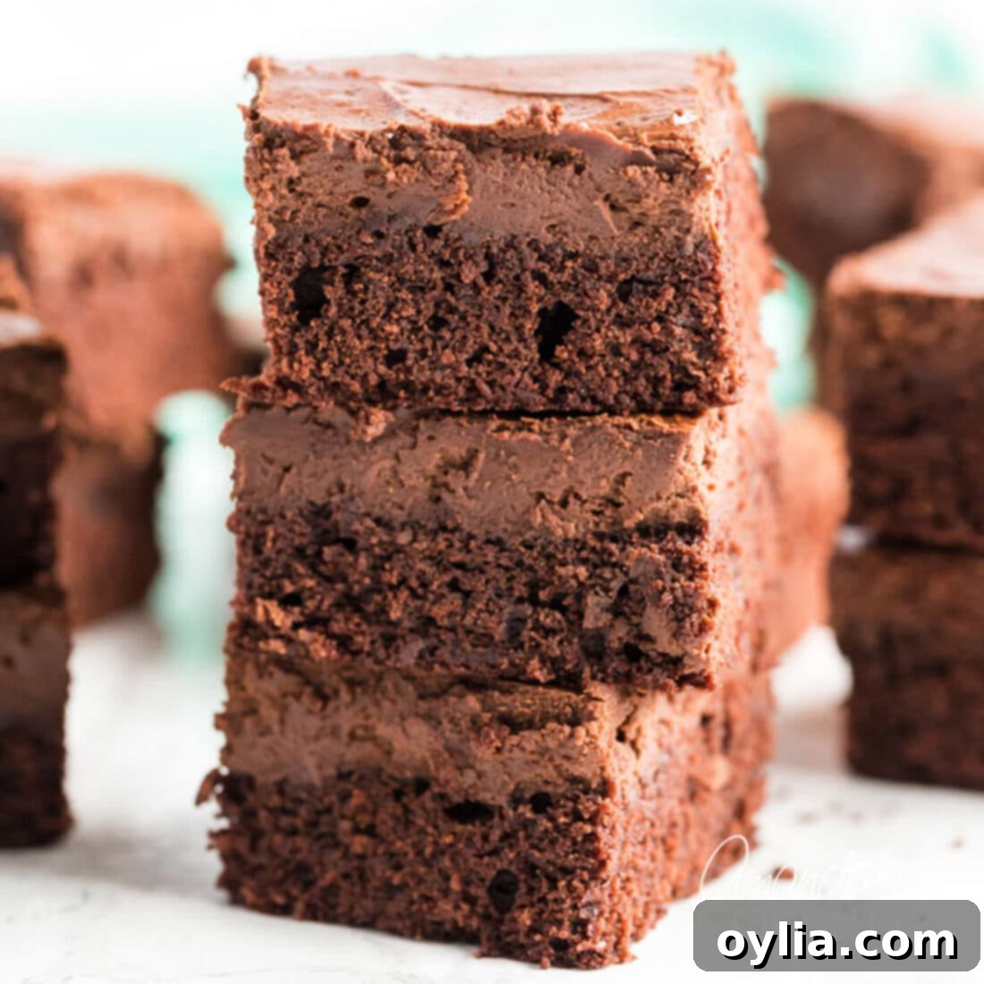 A stack of three perfectly layered Chocolate Cheesecake Brownies