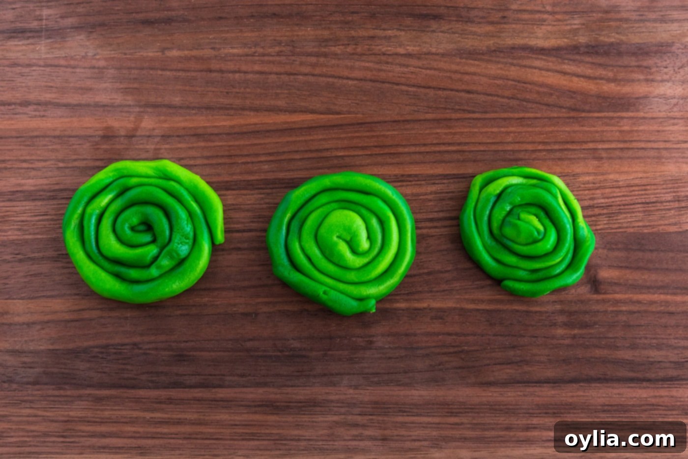 Preparing green dough circles for shamrock cookies.