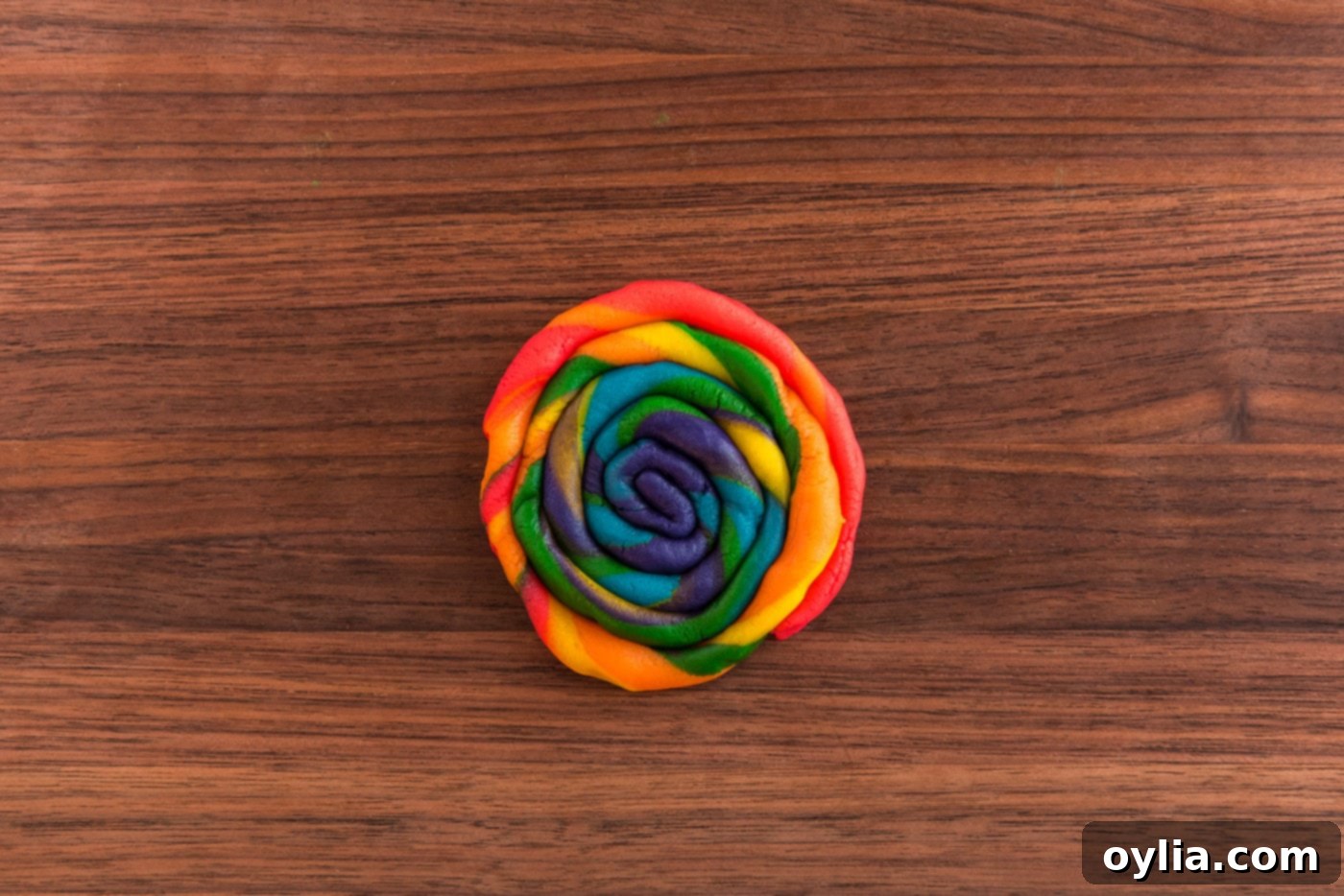 Rainbow cookie dough in a coiled shape.
