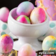 A bowl of dyed Easter eggs displaying a variety of vibrant tie-dye patterns