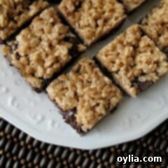 A close up photo of chewy cookie crunch bars on a white plate.
