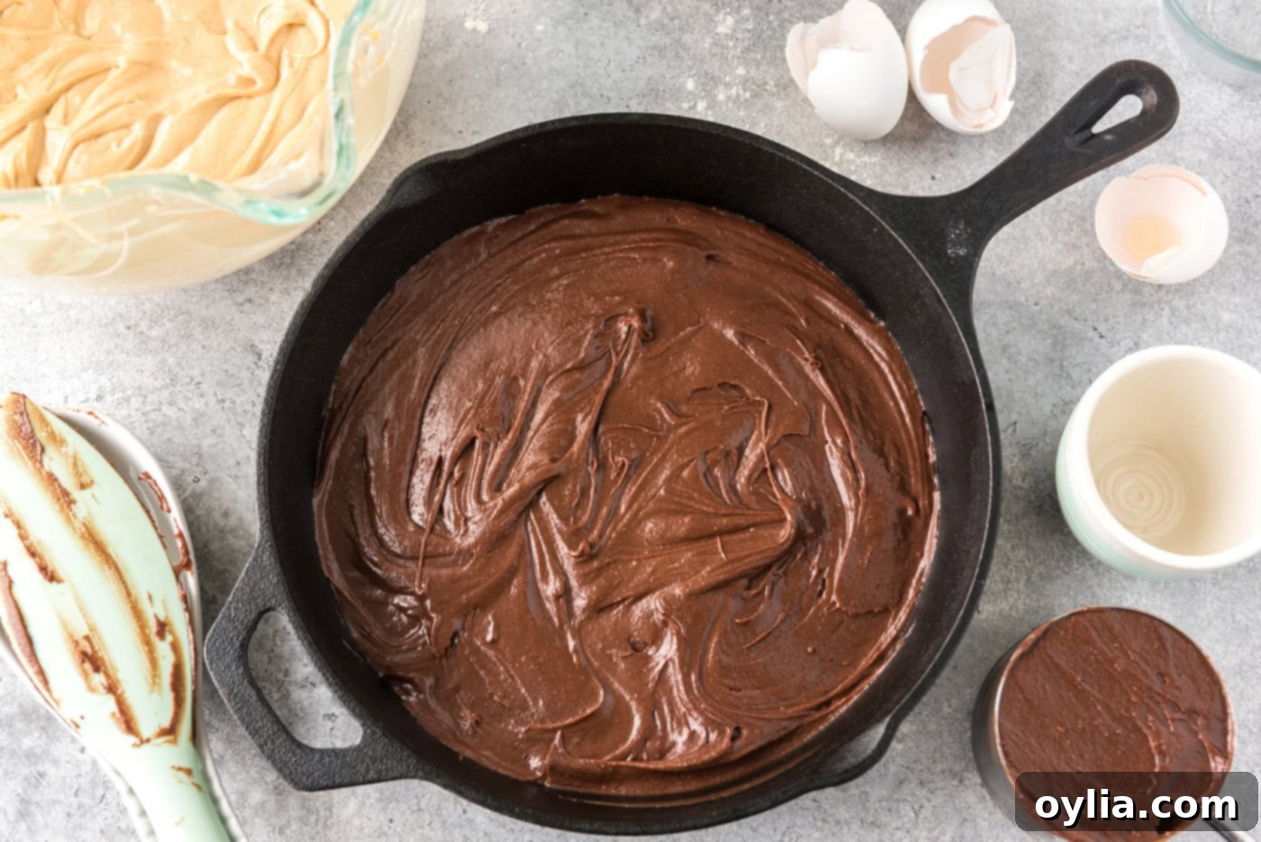 brownie batter added to a cast iron skillet
