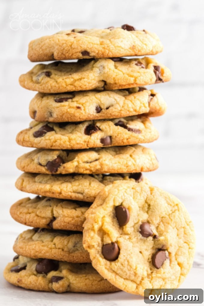 Tall stack of perfectly baked, soft and chewy Chocolate Chip Pudding Cookies, ready to be enjoyed.