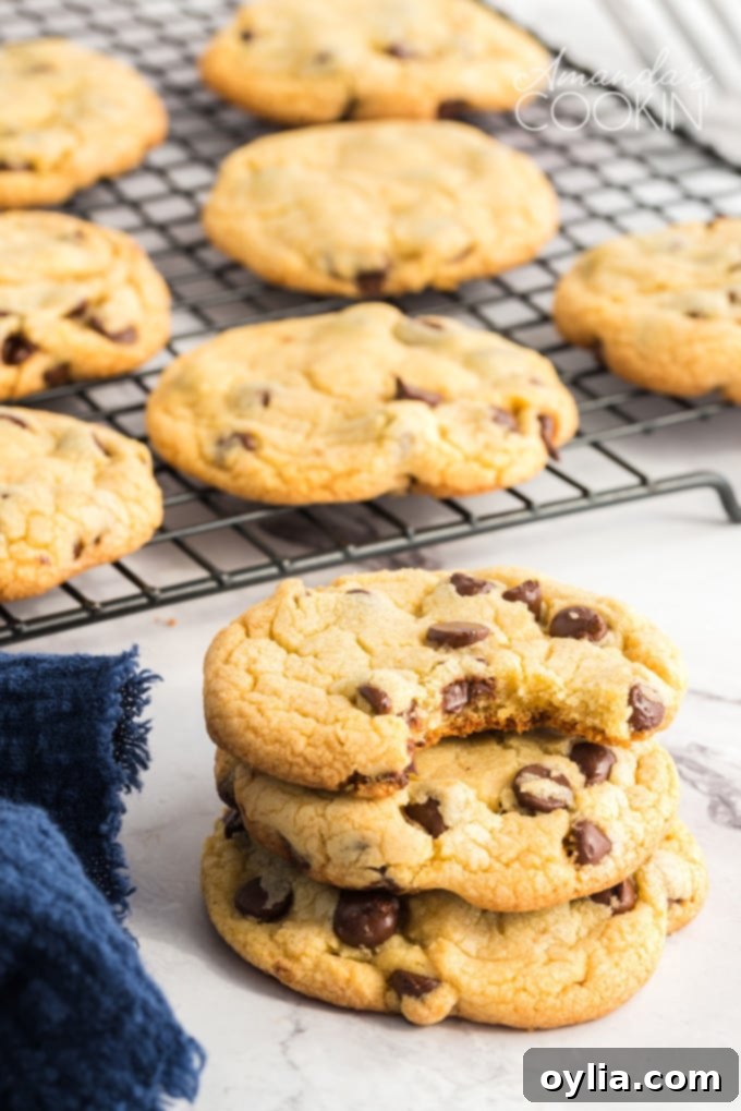 Close-up of freshly baked Chocolate Chip Pudding Cookies on a cooling rack, showcasing their perfect texture and golden hue.
