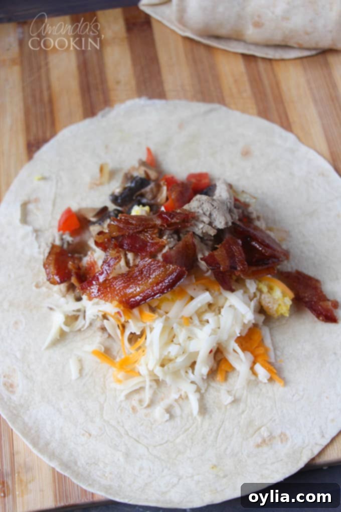 An overhead picture of an open tortilla with cheese, bacon and scrambled eggs laying on a wooden cutting board.