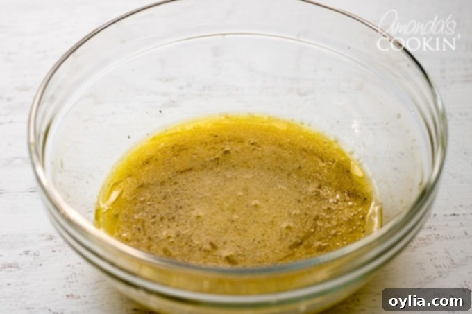 A close-up view of the smooth, emulsified dressing for the summer vegetable quinoa salad.