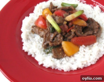 Delicious Beef Stir Fry with Tomatoes and Peppers served over rice