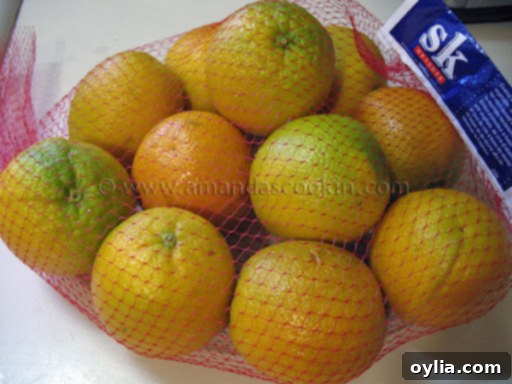 A bag of Sunkist Valencia oranges, some showing re-greening