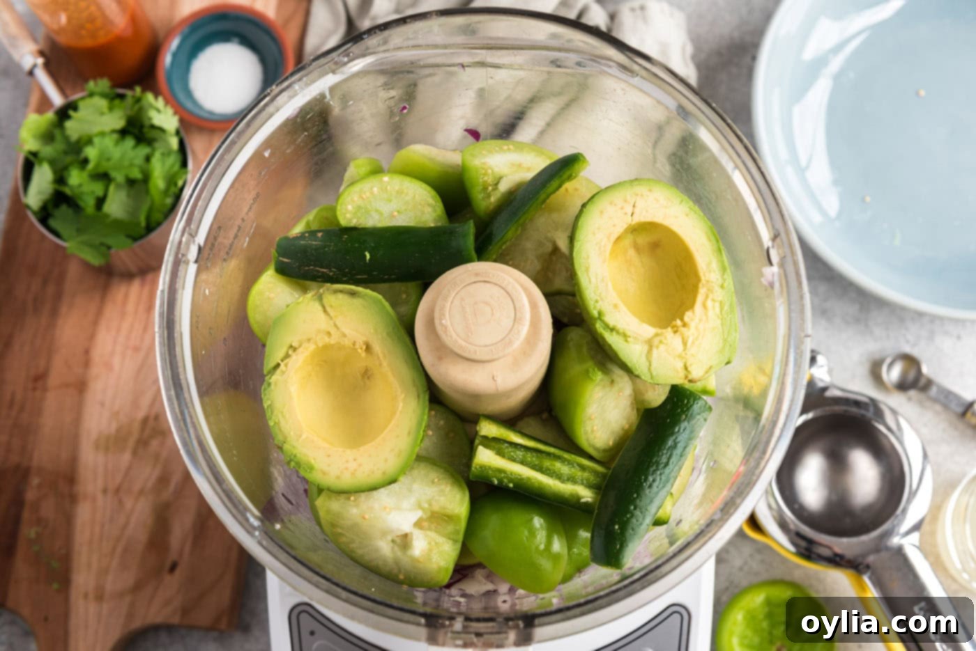 avocado and serrano chile pepper added to food processor with red onion