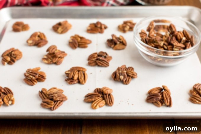 mounds of toasted pecans on a baking sheet