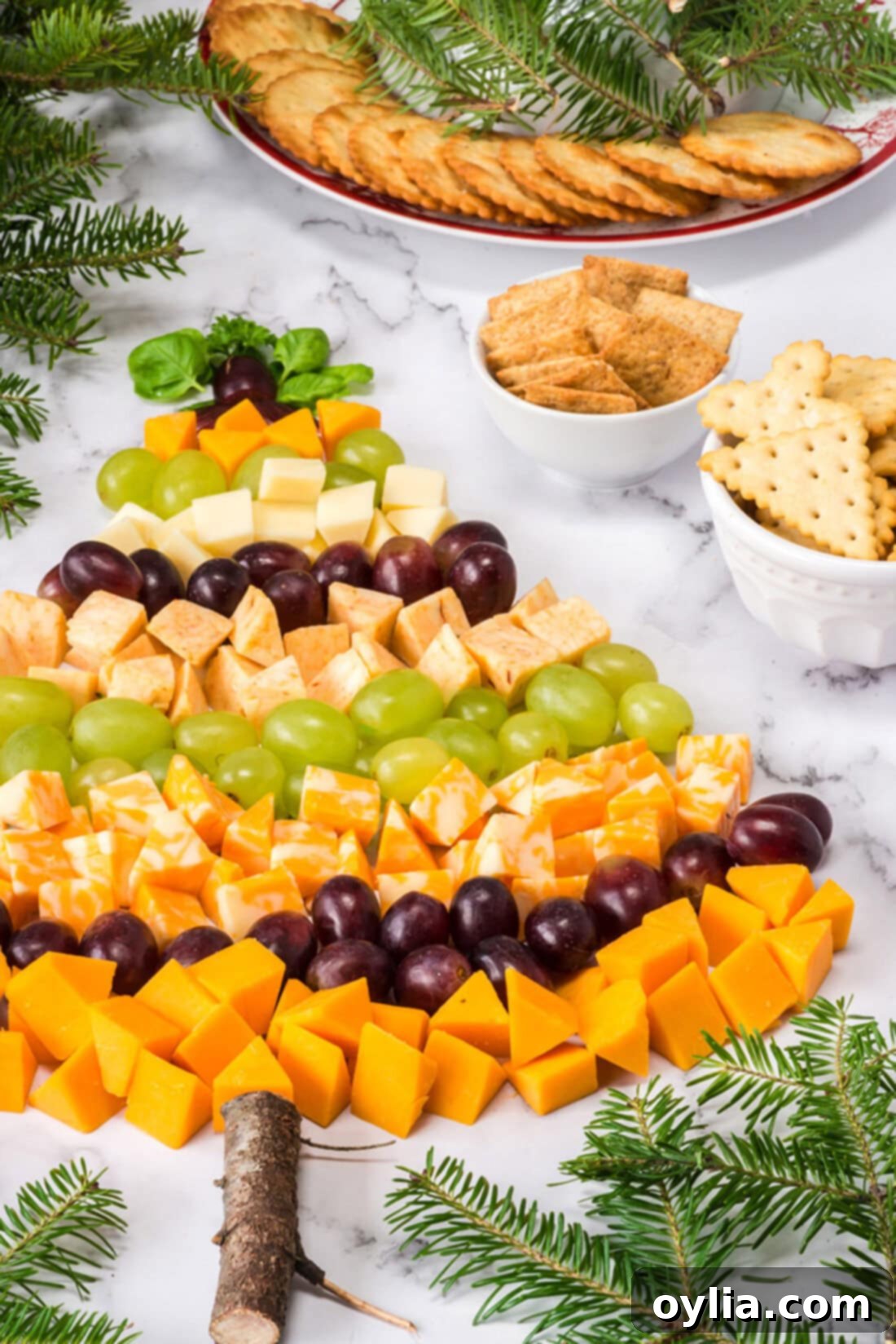 Close-up view of the Christmas Tree Cheese Platter, showcasing the intricate arrangement of cheeses, grapes, and garnishes