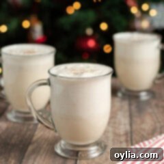 Velvety Holiday Eggnog 11 Close up photo of three mugs full of Homemade Eggnog
