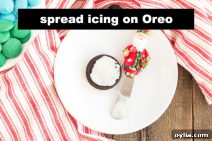 A single Oreo cookie with white powdered sugar glaze spread on top.