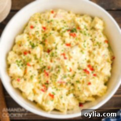 Mom's Signature Potato Salad 8 A beautifully presented bowl of creamy potato salad, garnished and ready to be enjoyed.