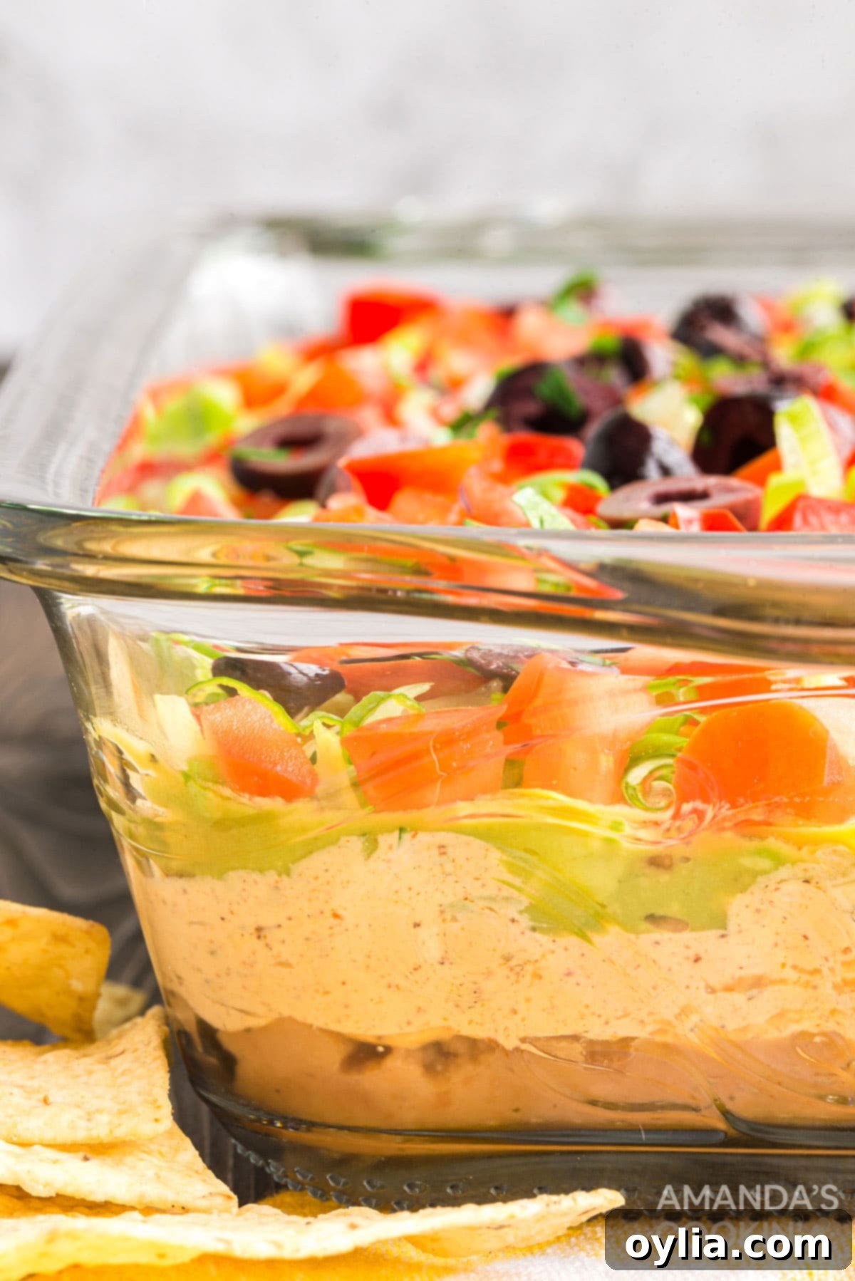 side view of glass pan with taco dip showing layers