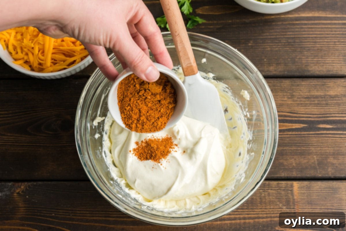 adding taco seasoning to sour cream and cream cheese