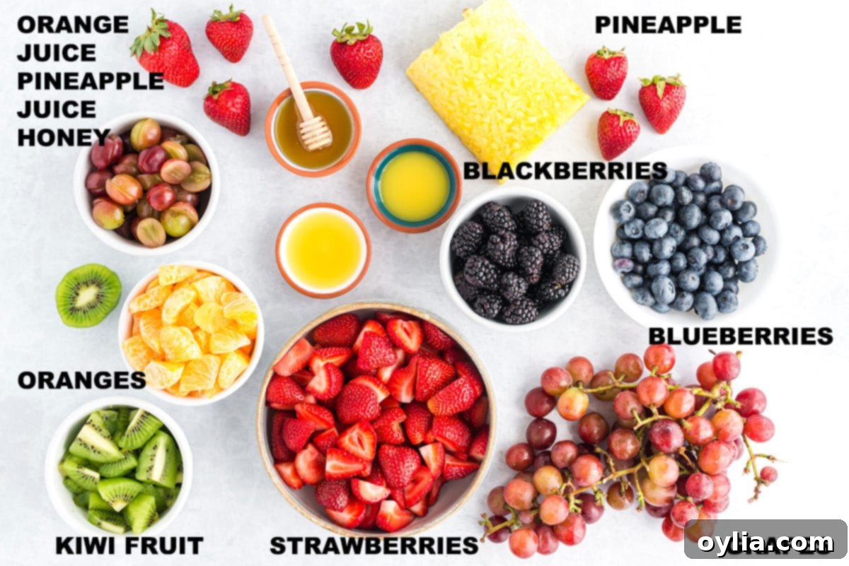 Labeled ingredients laid out for making the fruit salad, including various fresh fruits and dressing components