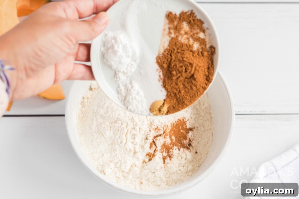 A bowl of dry ingredients for quick bread, including flour, spices, and leavening agents, being combined.