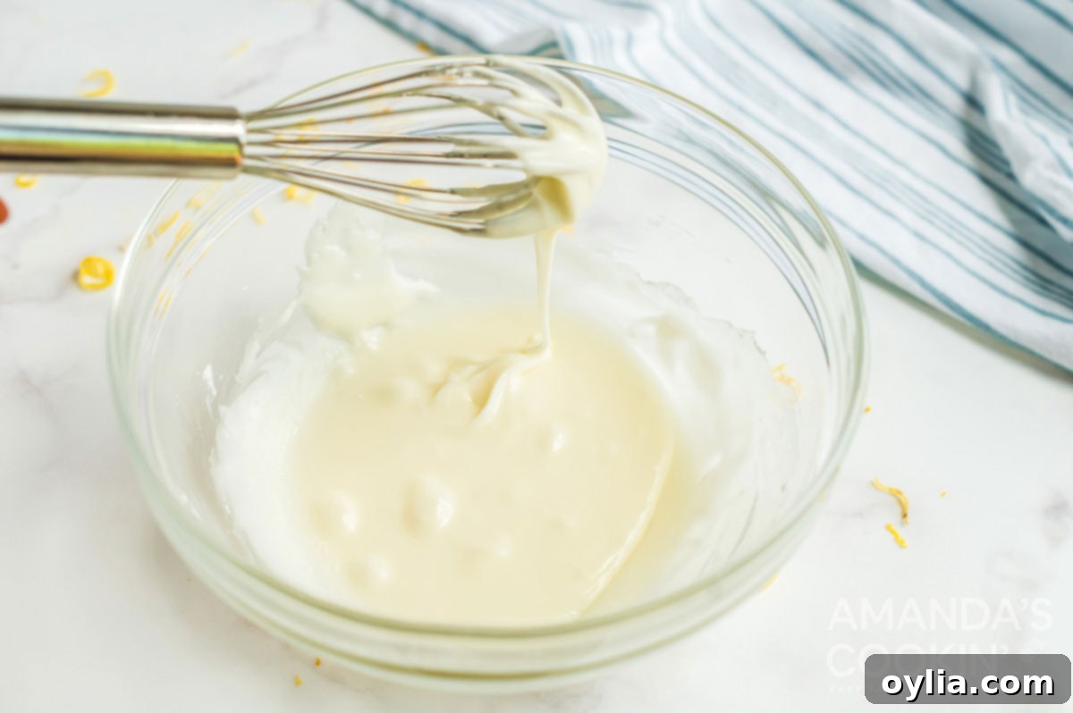 glaze dripping off whisk, showcasing its smooth and thick consistency